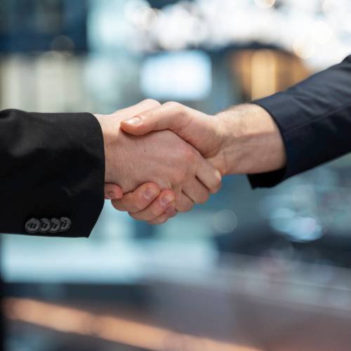 side-view-colleagues-shaking-hands-work